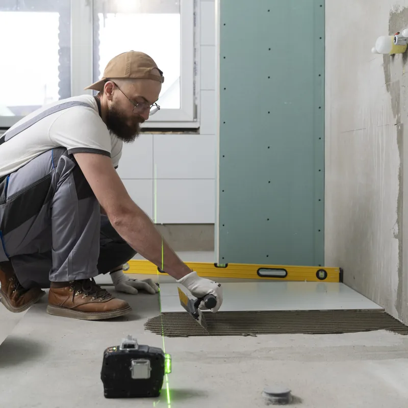 Tile installation: setting a large floor tile with a laser layout guide