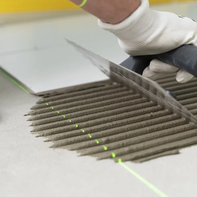 Tile installation preparation: spreading mortar with a notched trowel